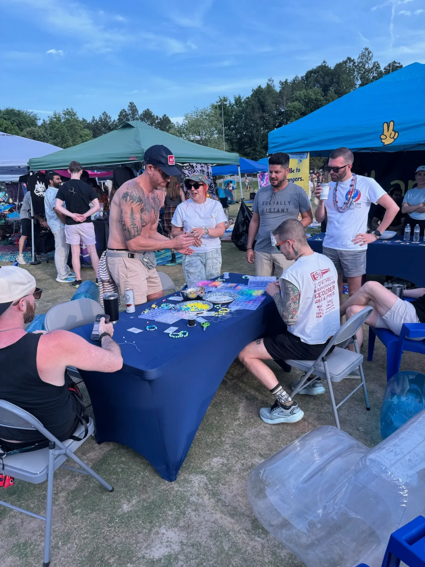 Guys at bracelet-making table