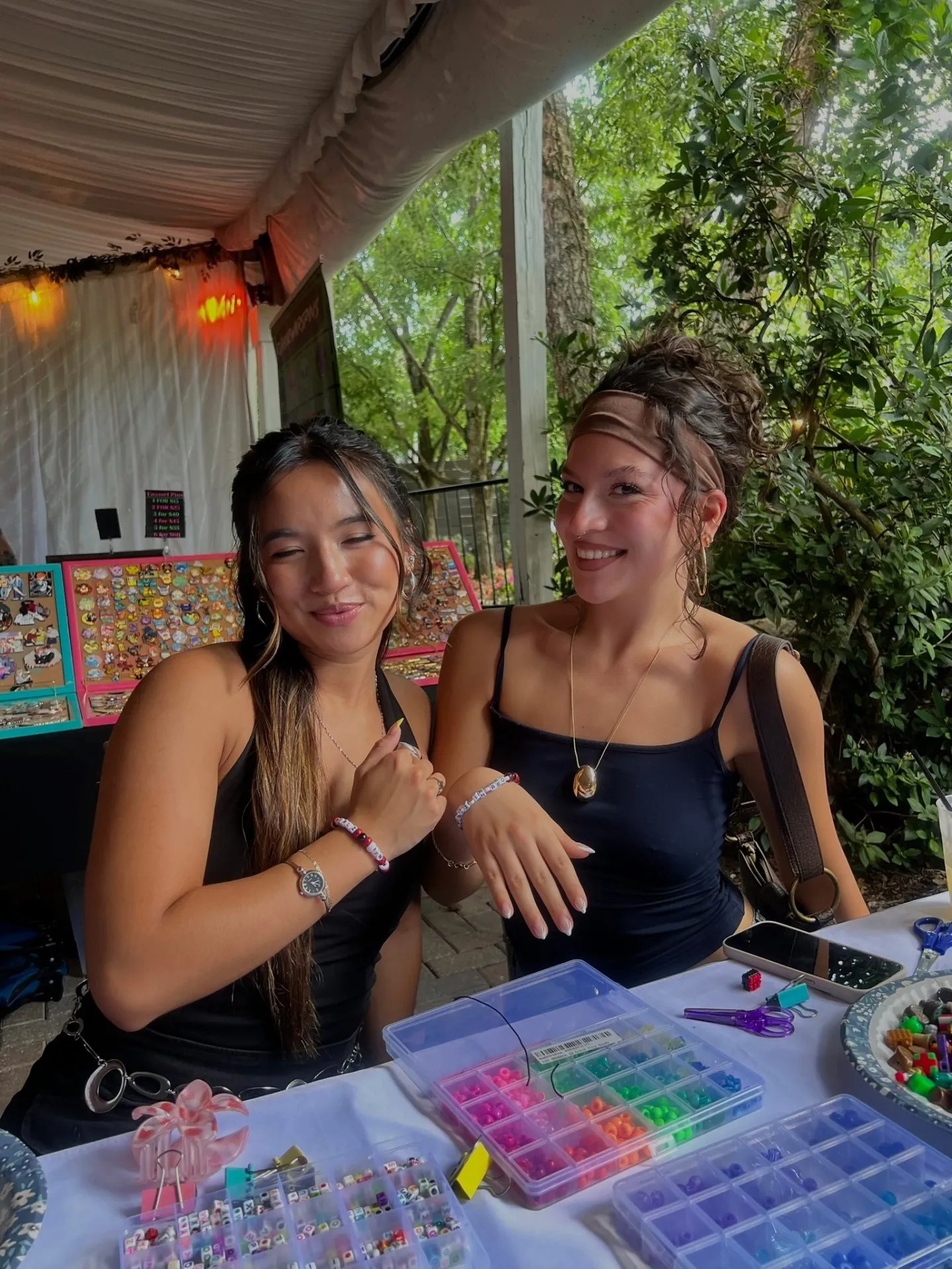 Two girls making friendship bracelets
